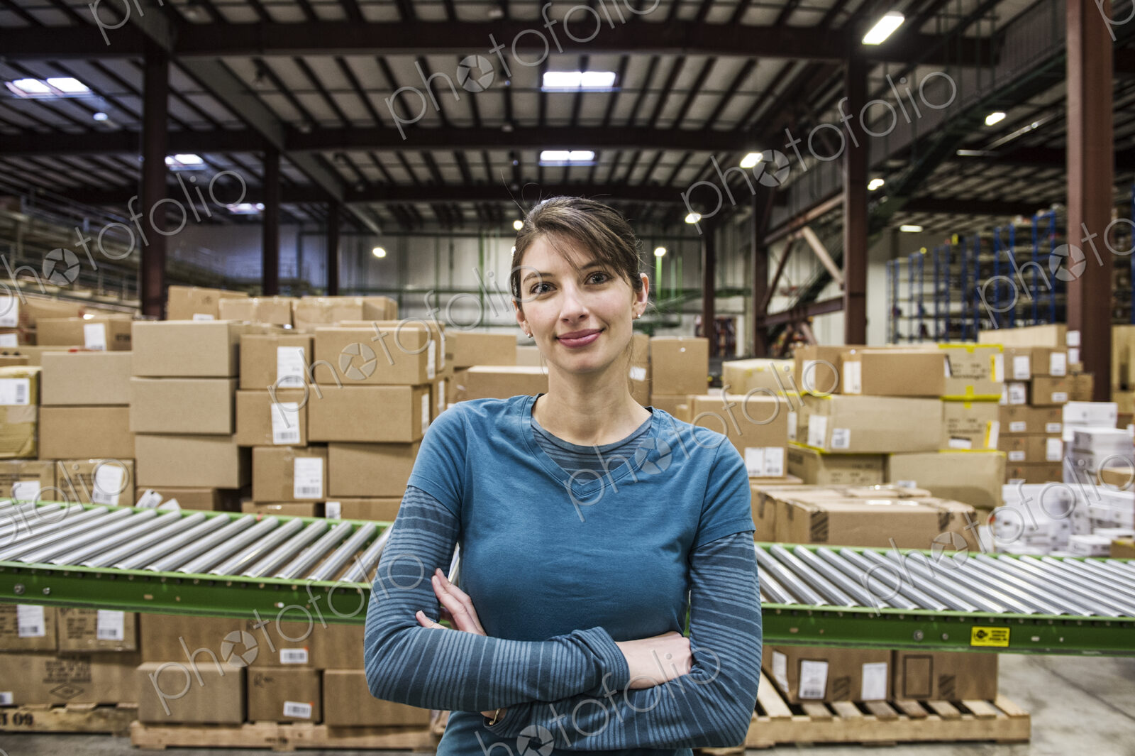 A caucasian female warehouse worker in a distribution warehouse.