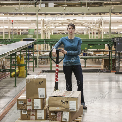 A caucasian female warehouse worker in a distribution warehouse.