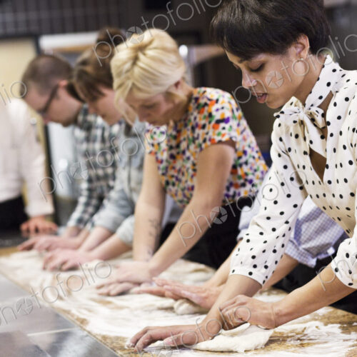 A caucasian male chef teaching a cooking class, multi ethnic group. A caucasian male chef teaching a cooking class, multi ethnic group.