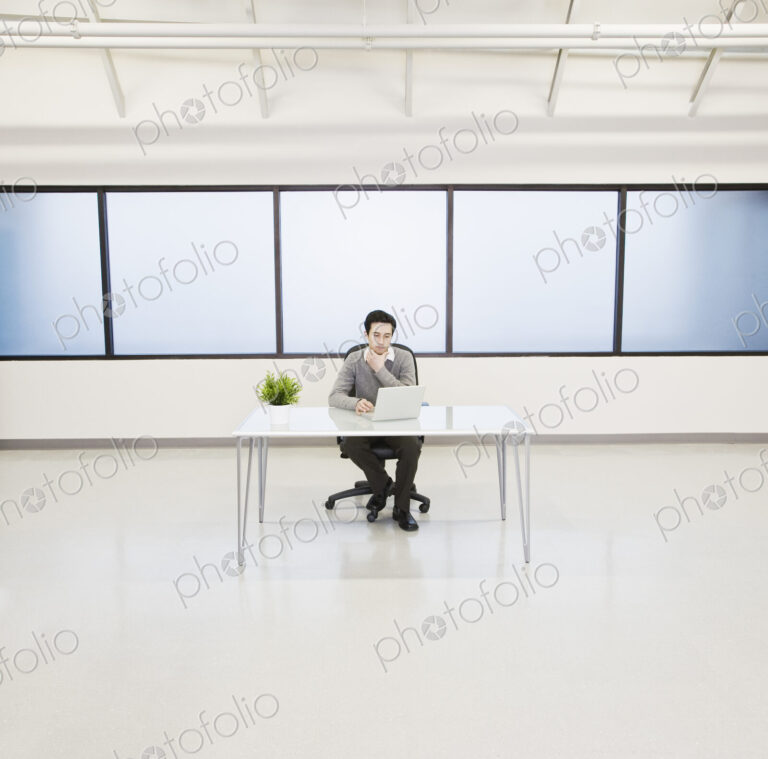 A caucasian man lab techncian working in the office of a computer server farm.