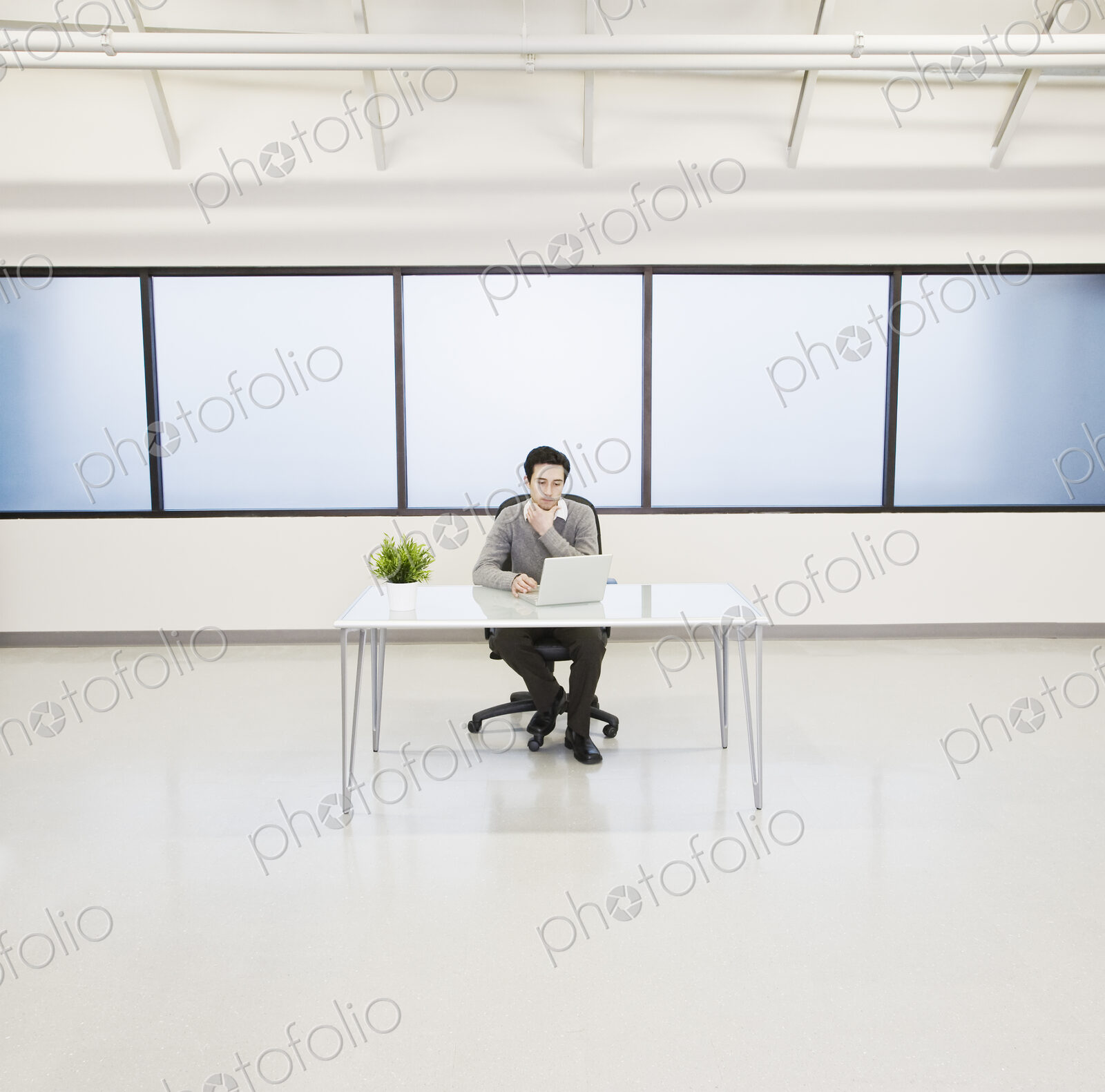 A caucasian man lab technician working in the office of a computer server farm.