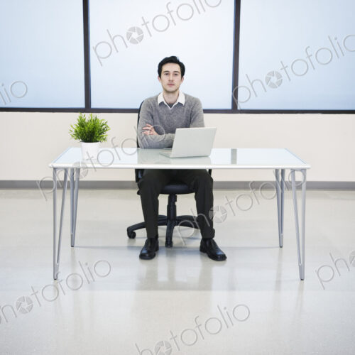 A caucasian man lab techncian working in the office of a computer server farm. A caucasian man lab techncian working in the office of a computer server farm.