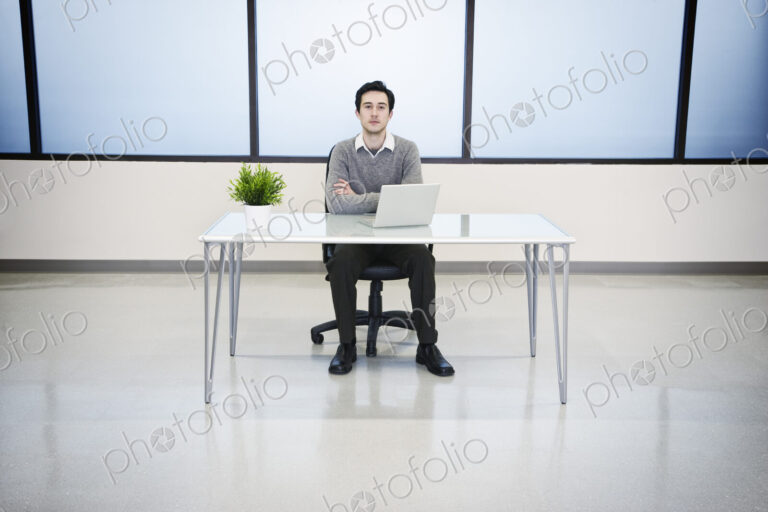 A caucasian man lab techncian working in the office of a computer server farm.