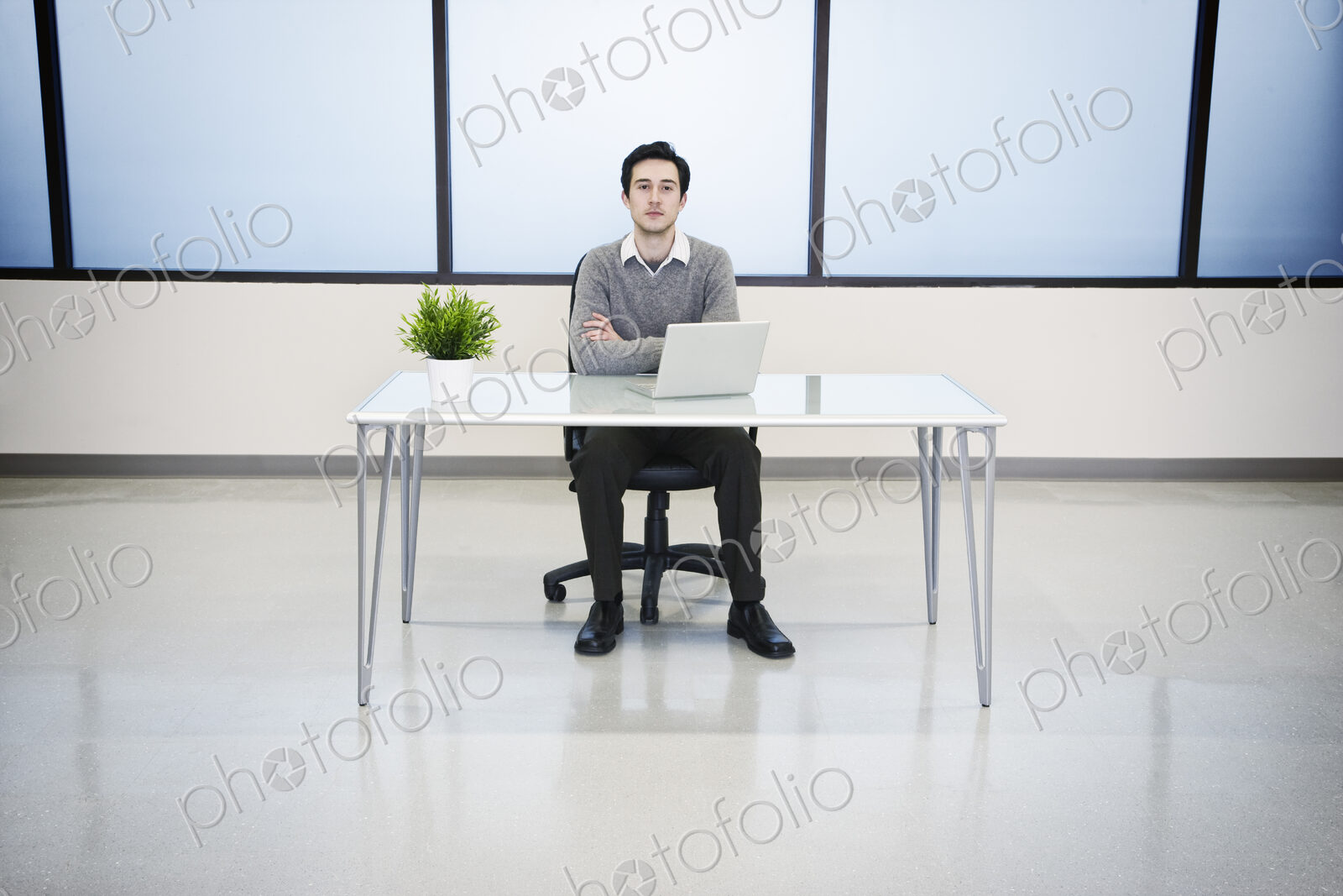 A caucasian man lab technician working in the office of a computer server farm.