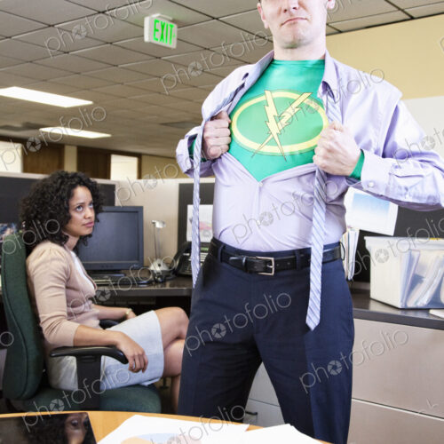 A caucasian man office super hero gets ready for action in his office. A caucasian man office super hero gets ready for action in his office.