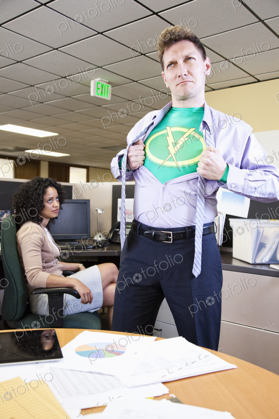 A caucasian man office super hero gets ready for action in his office.