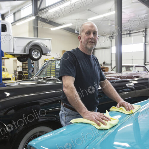A caucasian senior male car mechnic in ihs classic car repair shop. A caucasian senior male car mechnic in ihs classic car repair shop.