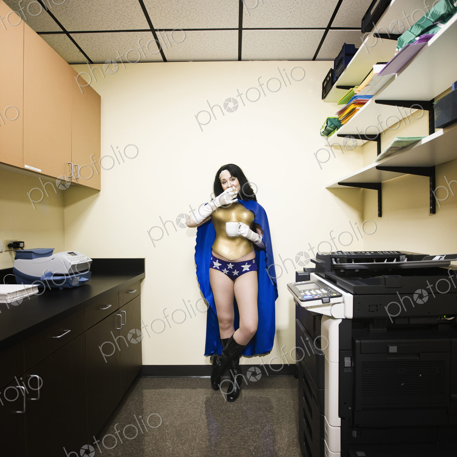 A caucasian woman office super hero takes a break and has snack.