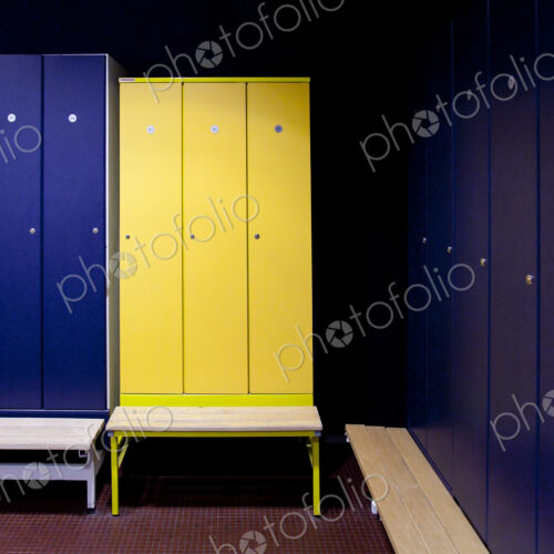 A changing room with blue and yellow locker doors in a spa hotel.