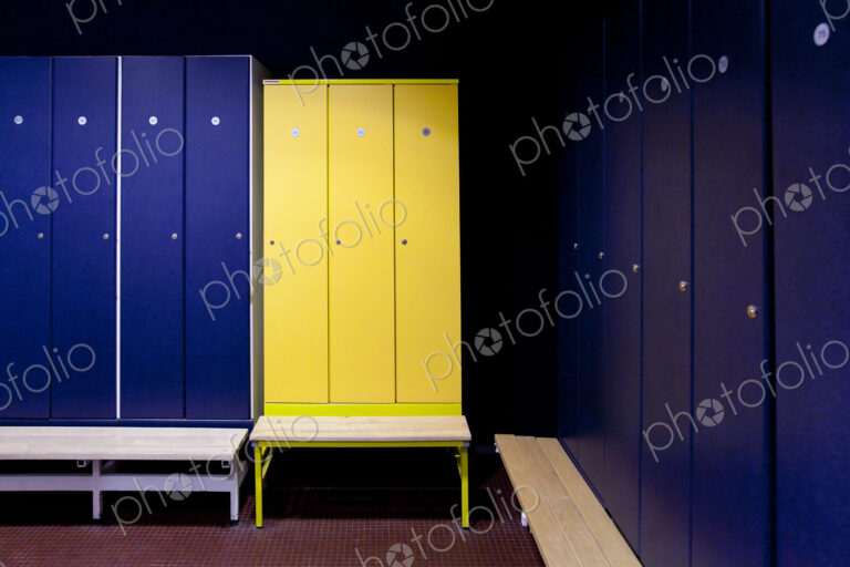 A changing room with blue and yellow locker doors in a spa hotel.