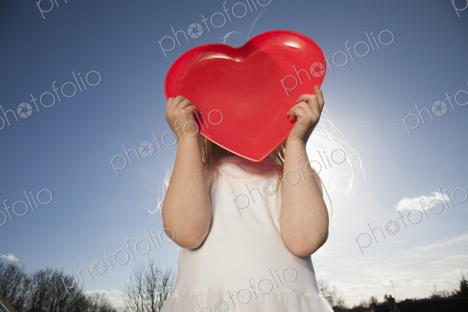 A child holding a red heart shape.