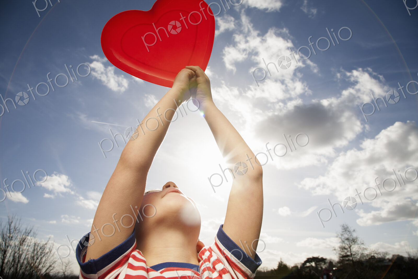 A child holding a red heart shape.