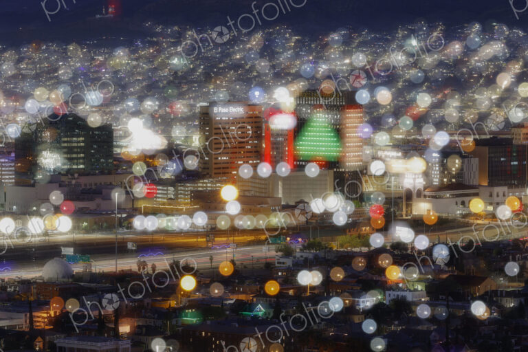 A city at night, blurred view, pinpoints of light, a cityscape, buildings and colours.