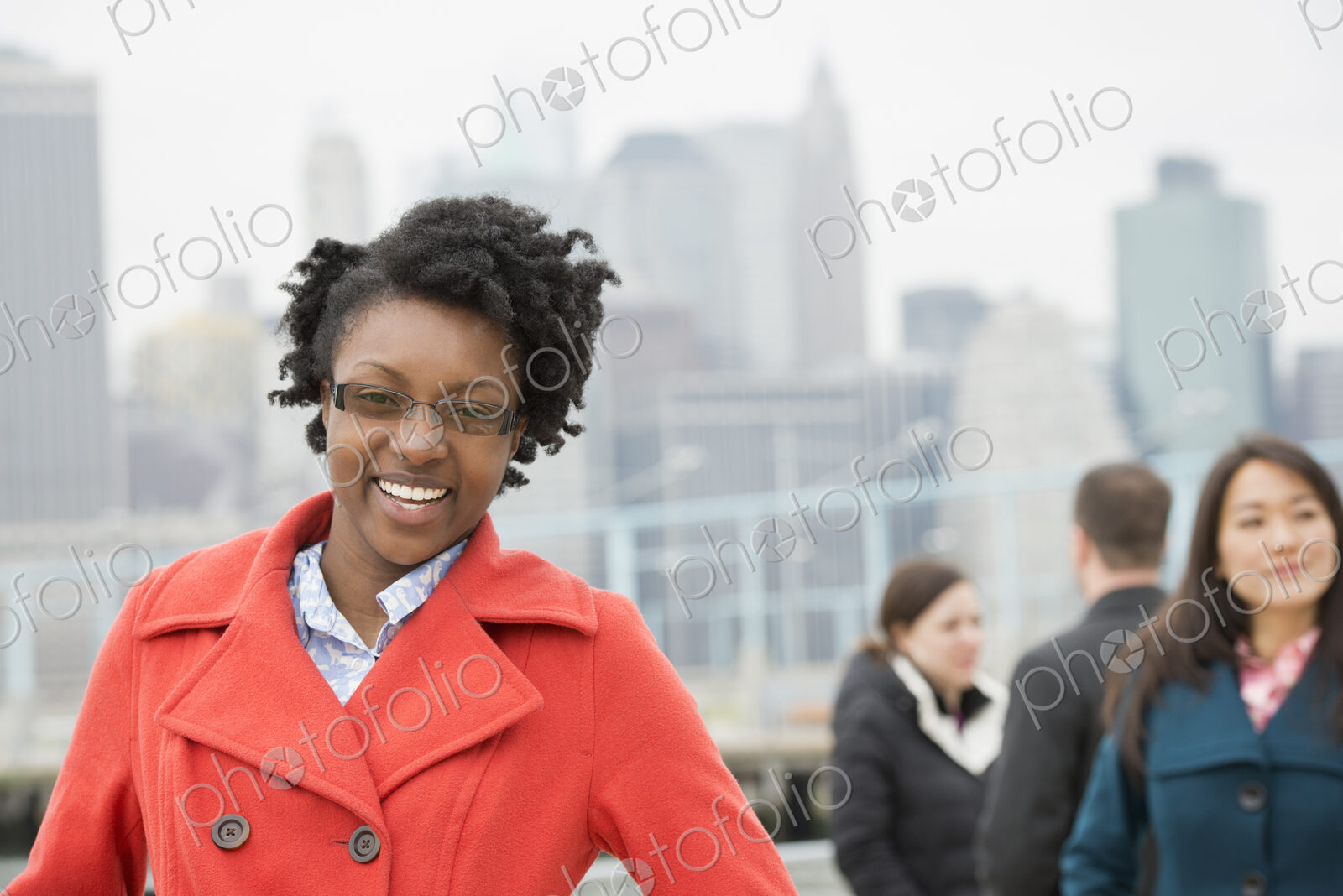 A cityscape, view to Manhattan from Brooklyn. Four people, two in the background…