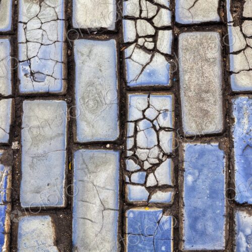 A close-up view of cracked blue cobblestones lining the historic streets of Old San… A close-up view of cracked blue cobblestones lining the historic streets of Old San…