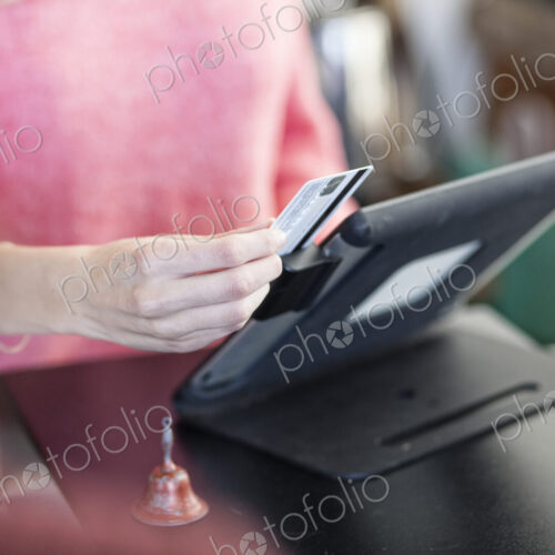 A closeup of a credit card being swiped in a credit card transaction. A closeup of a credit card being swiped in a credit card transaction.