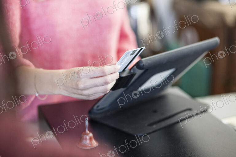 A closeup of a credit card being swiped in a credit card transaction.