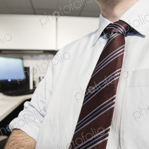 A closeup of a shirt and tie on a businessman.