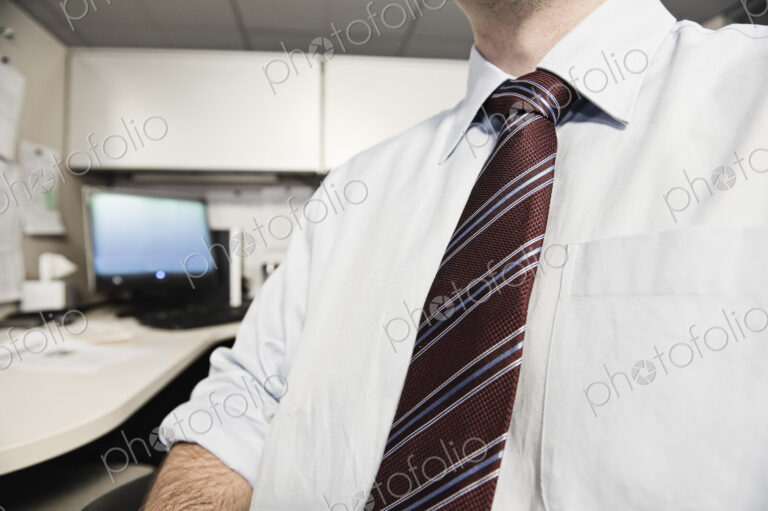 A closeup of a shirt and tie on a businessman.