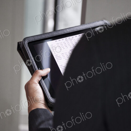 A closeup of hands holding a notebook computer. A closeup of hands holding a notebook computer.
