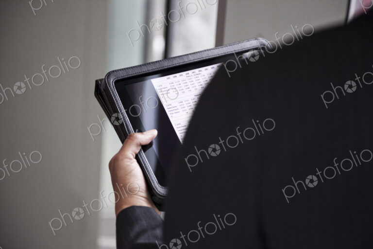 A closeup of hands holding a notebook computer.