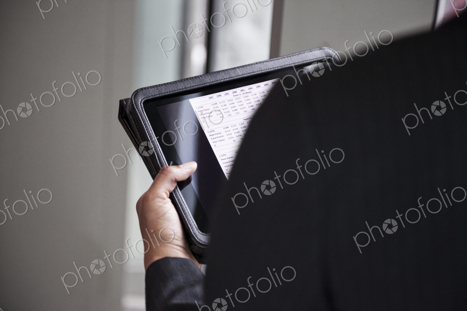 A closeup of hands holding a notebook computer.