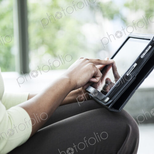 A closeup of the hands of a black businesswoman working on a ntoebook computer. A closeup of the hands of a black businesswoman working on a ntoebook computer.