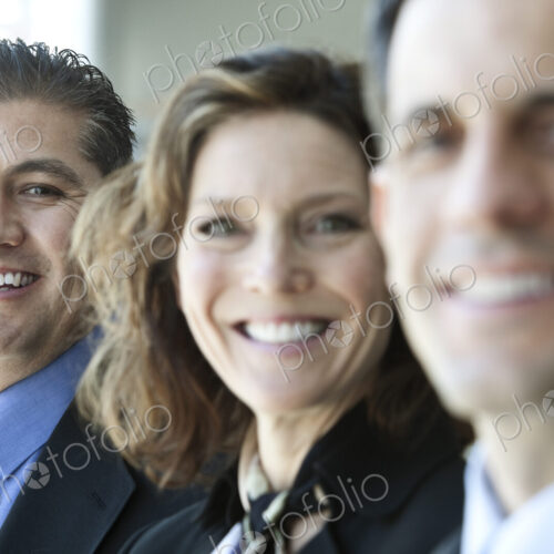 A closeup portrait of a row of multi ethnic business people, with focus on the…