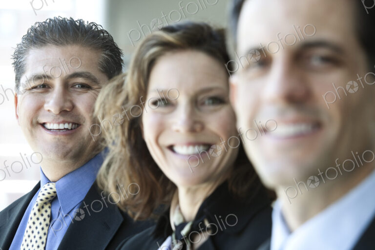 A closeup portrait of a row of multi ethnic business people, with focus on the…