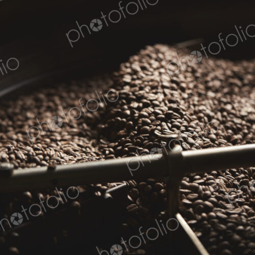 A coffee shop. A drum of roasting coffee beans. A coffee shop. A drum of roasting coffee beans.