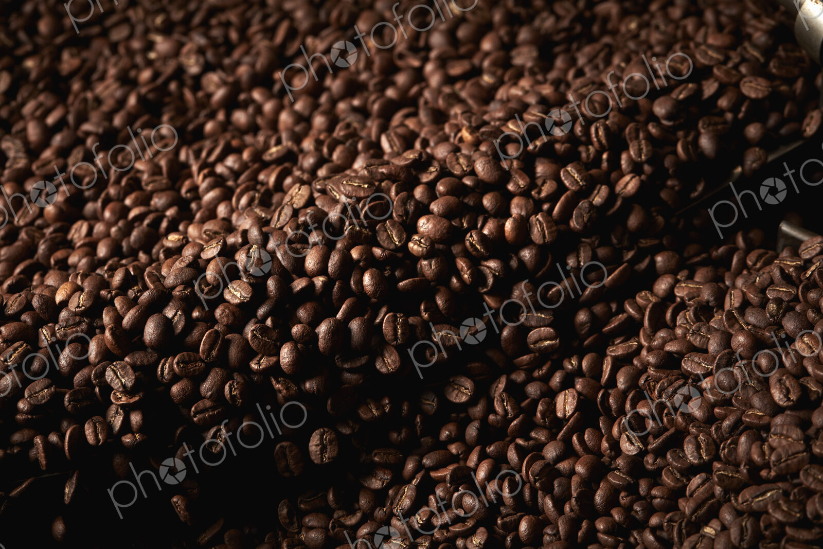 A coffee shop. A drum of roasting coffee beans.
