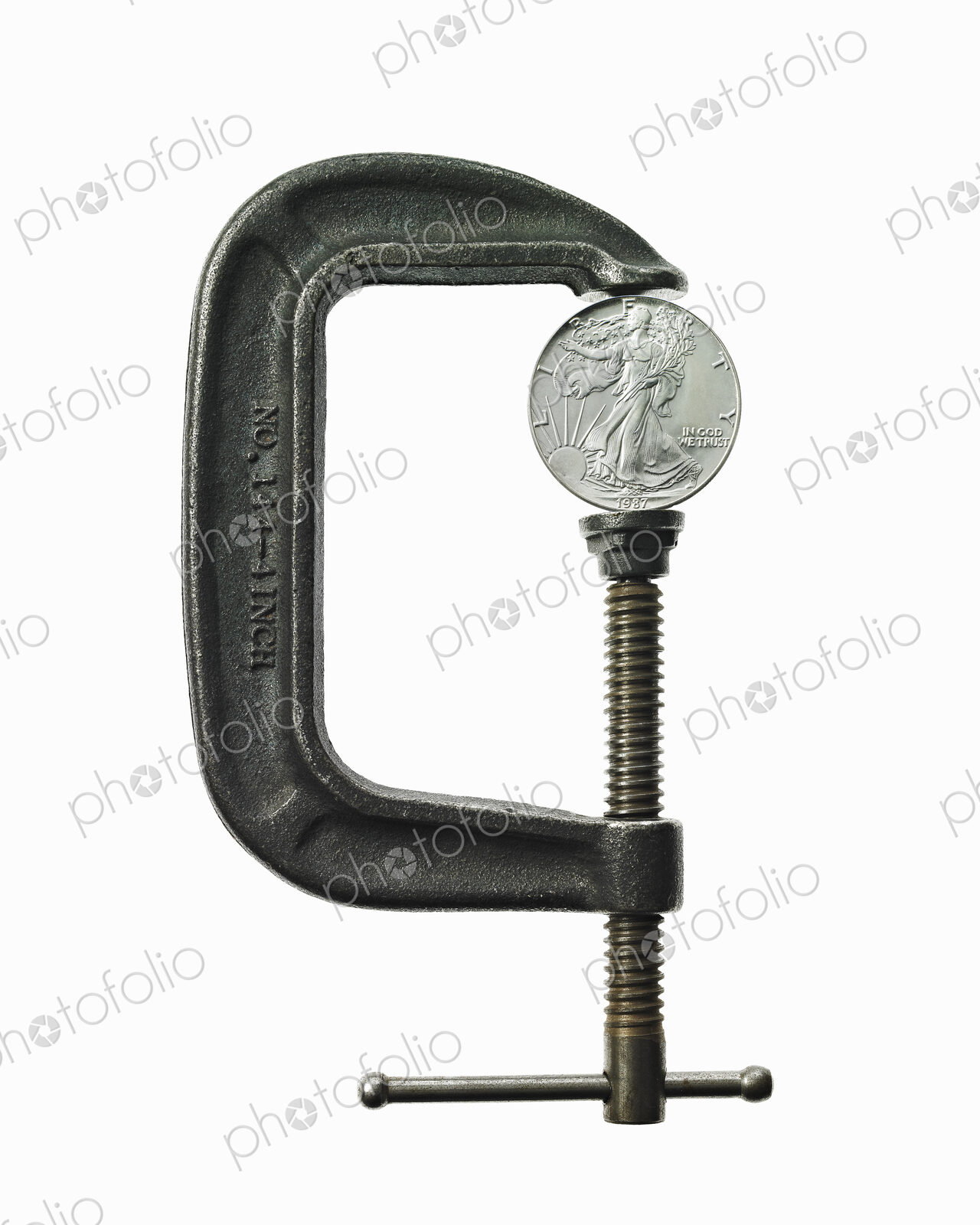 A coin in a clamp, conceptual shot.