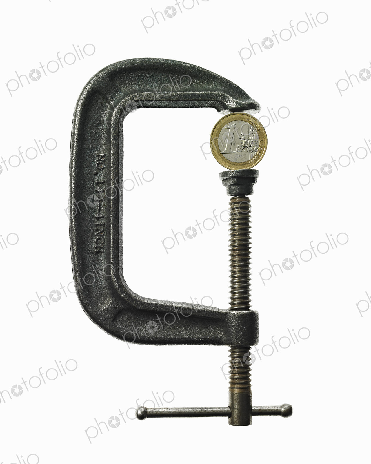 A coin in a clamp, conceptual shot.