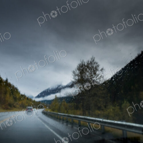 A cold wet day, low light, rain falling on the road, driver point of view. A cold wet day, low light, rain falling on the road, driver point of view.