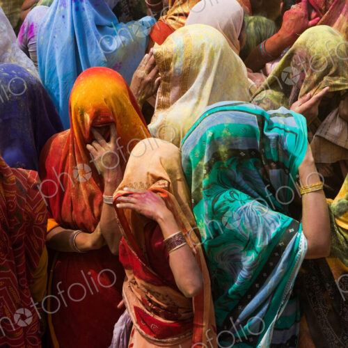A colorful crowd of people celebrate the Holi Festival, Mathura, Uttar Pradesh, India