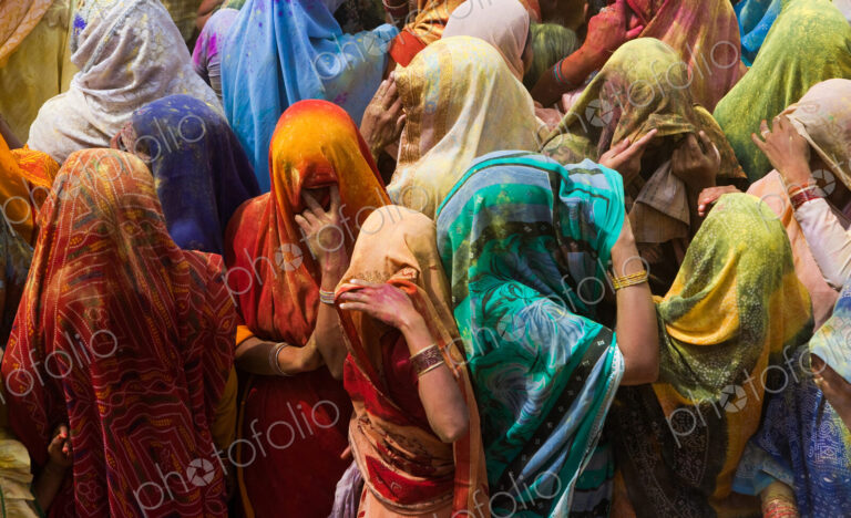 A colorful crowd of people celebrate the Holi Festival, Mathura, Uttar Pradesh, India