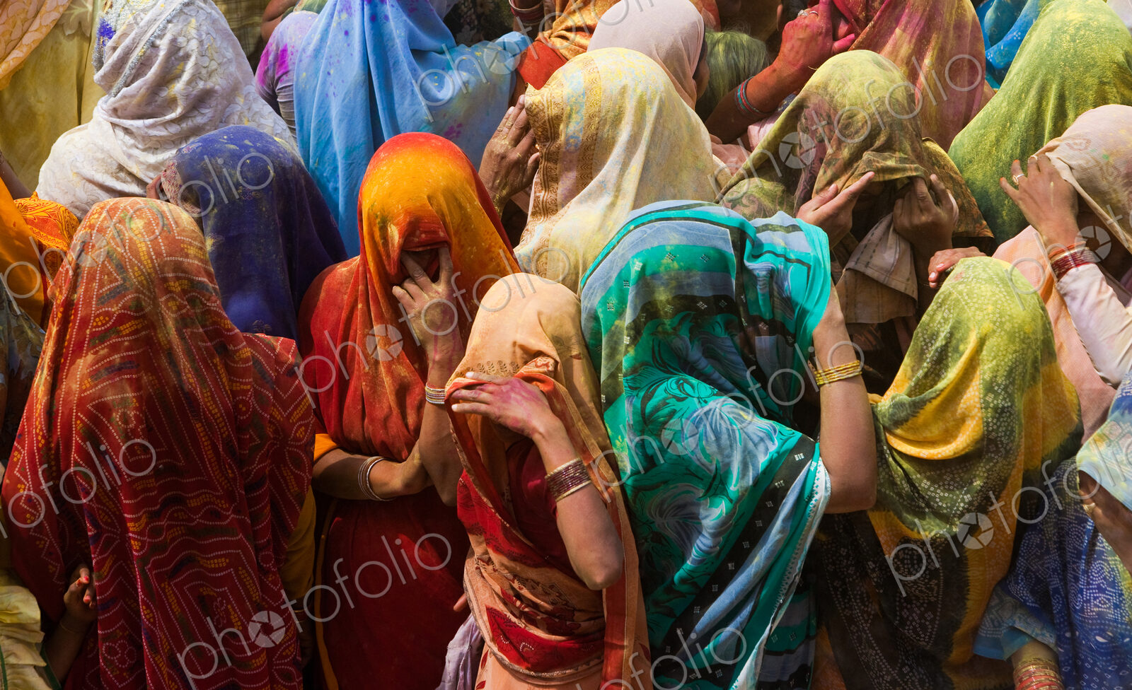 A colorful crowd of people celebrate the Holi Festival, Mathura, Uttar Pradesh, India