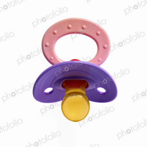 A coloured plastic baby pacifier, dummy or soother.