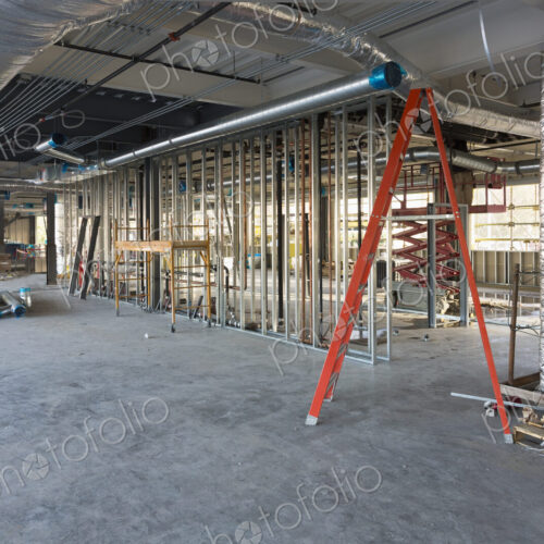 A commercial building under construction with roof ducts and light gauge steel framing.