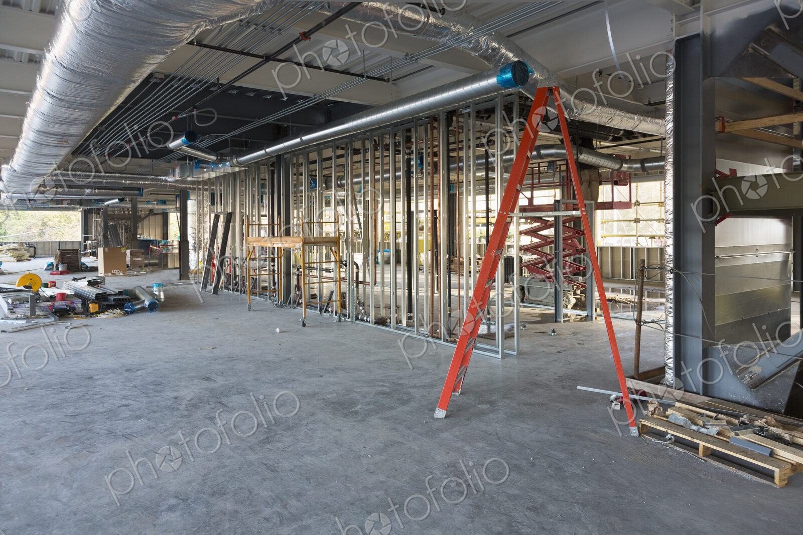 A commercial building under construction with roof ducts and light gauge steel framing.