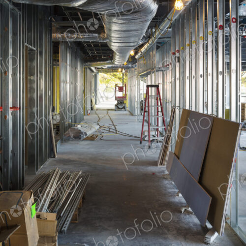 A commercial building under construction with roof ducts and light gauge steel framing.