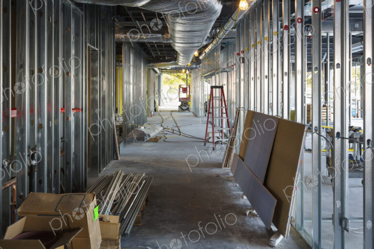 A commercial building under construction with roof ducts and light gauge steel framing.