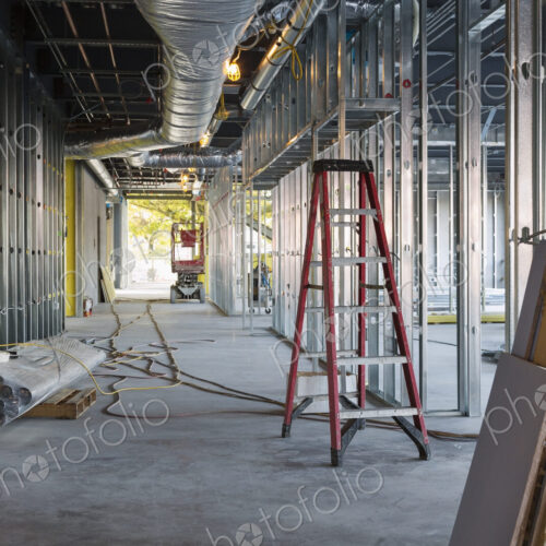 A commercial building under construction with roof ducts and light gauge steel framing.