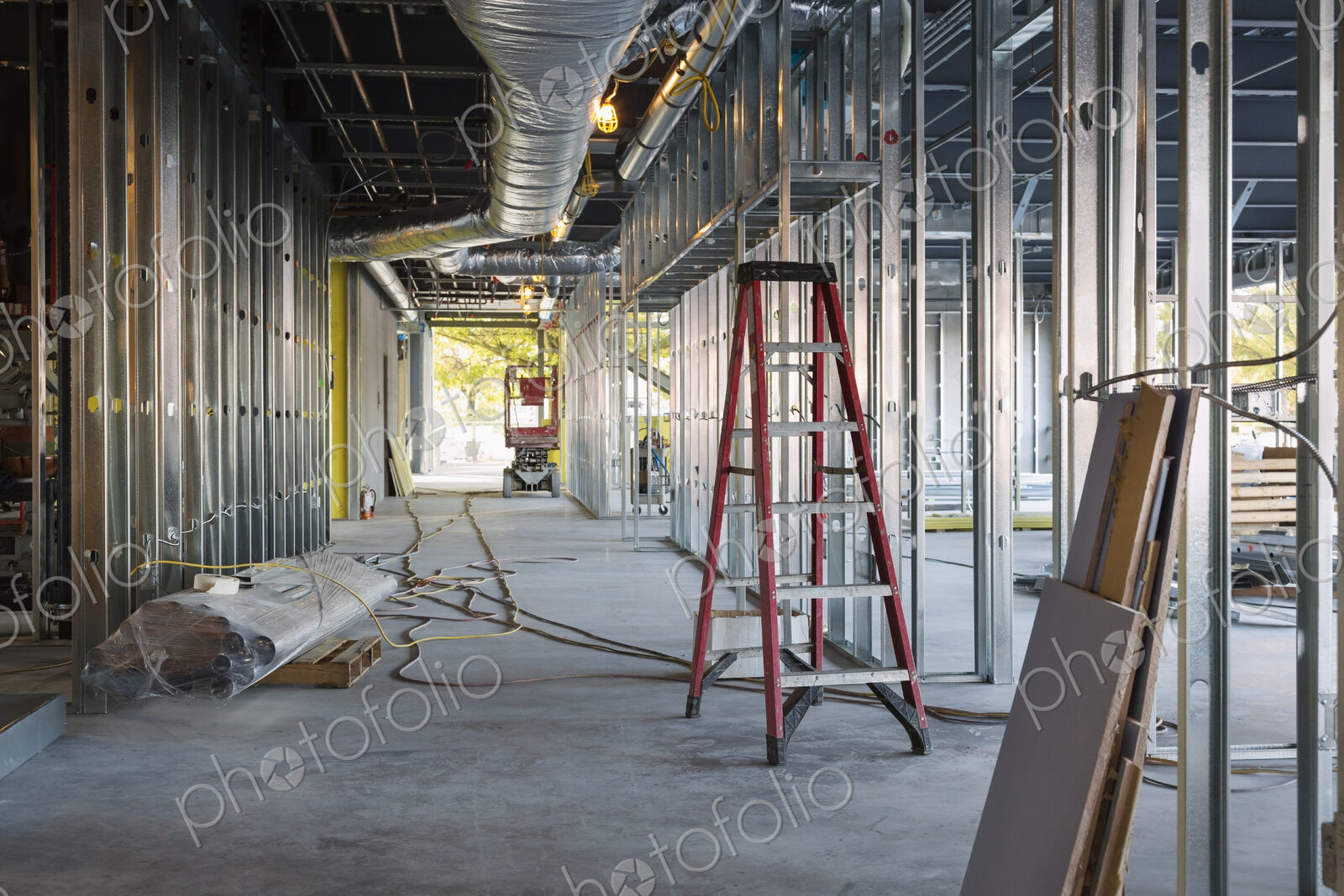 A commercial building under construction with roof ducts and light gauge steel framing.