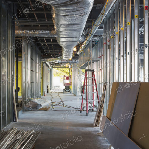A commercial building under construction with roof ducts and light gauge steel framing.