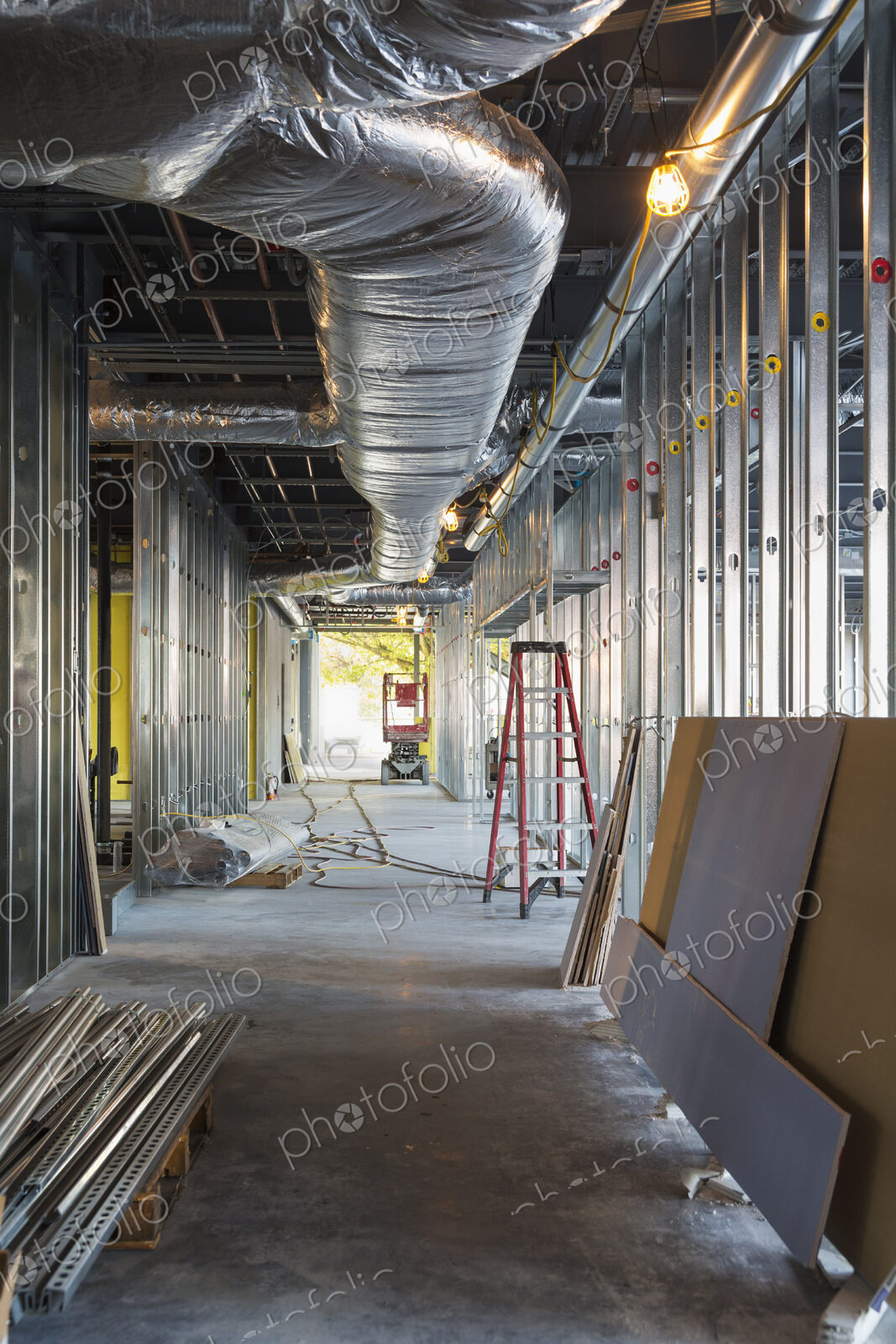 A commercial building under construction with roof ducts and light gauge steel framing.