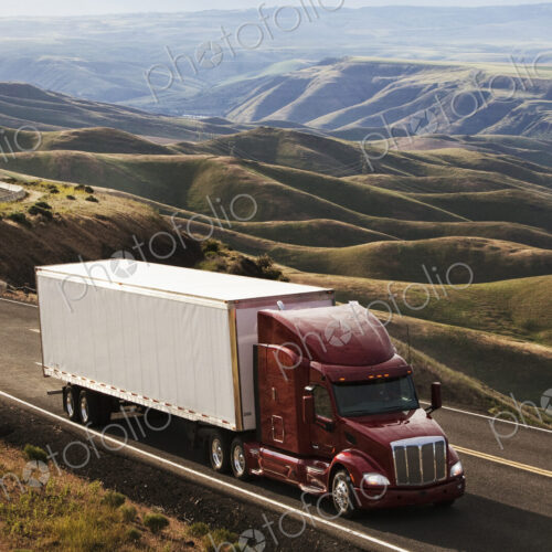 A commercial truck driving through the high rolling hills of southeastern Washington, USA