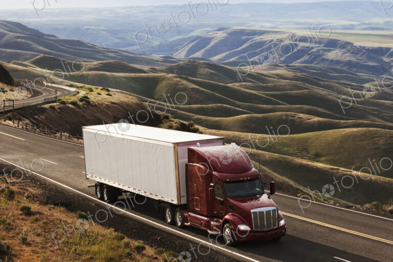 A commercial truck driving through the high rolling hills of southeastern Washington, USA