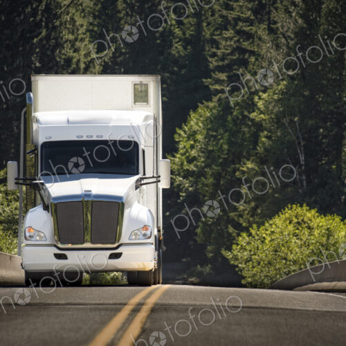 A commercial truck on the road. A commercial truck on the road.