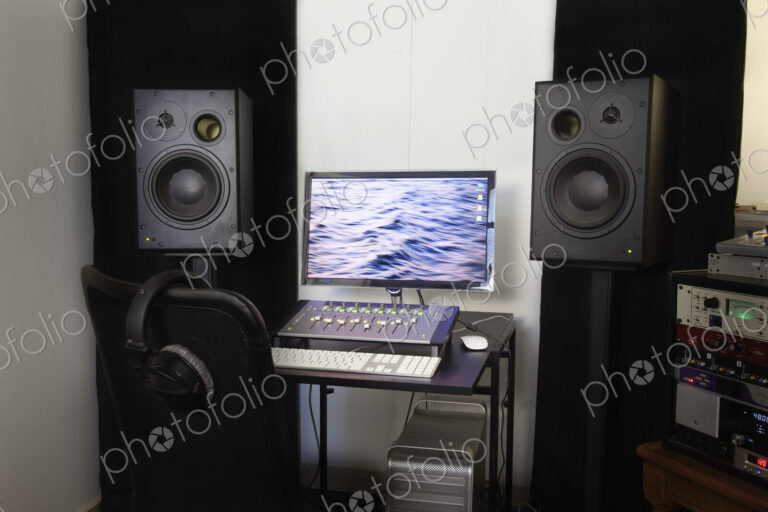 A computer workstation with sound board, speakers, headphones, recording deck and…